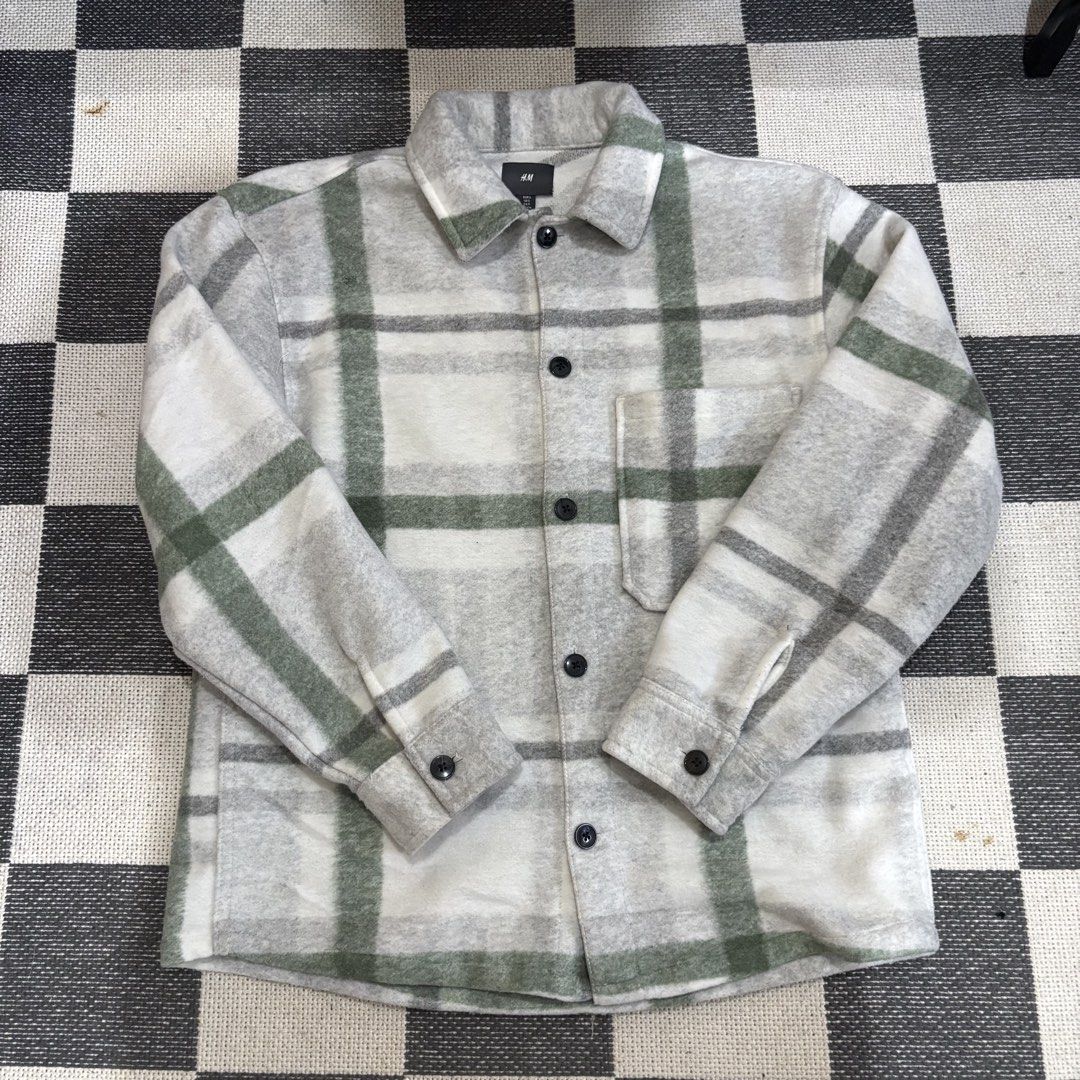 H&M Plaid Shirt Jacket Grey Green (Category: Coats, Jackets and Outerwear) located in Makati City. Submitted by sseurekiii (Listing ID 1463722063, Image 1). Description: - Grey and green plaid shirt jacket - Brand: H&M - Button-up front closure - Single chest pocket - Long sleeves with button cuffs - Cozy material, ideal for layering.