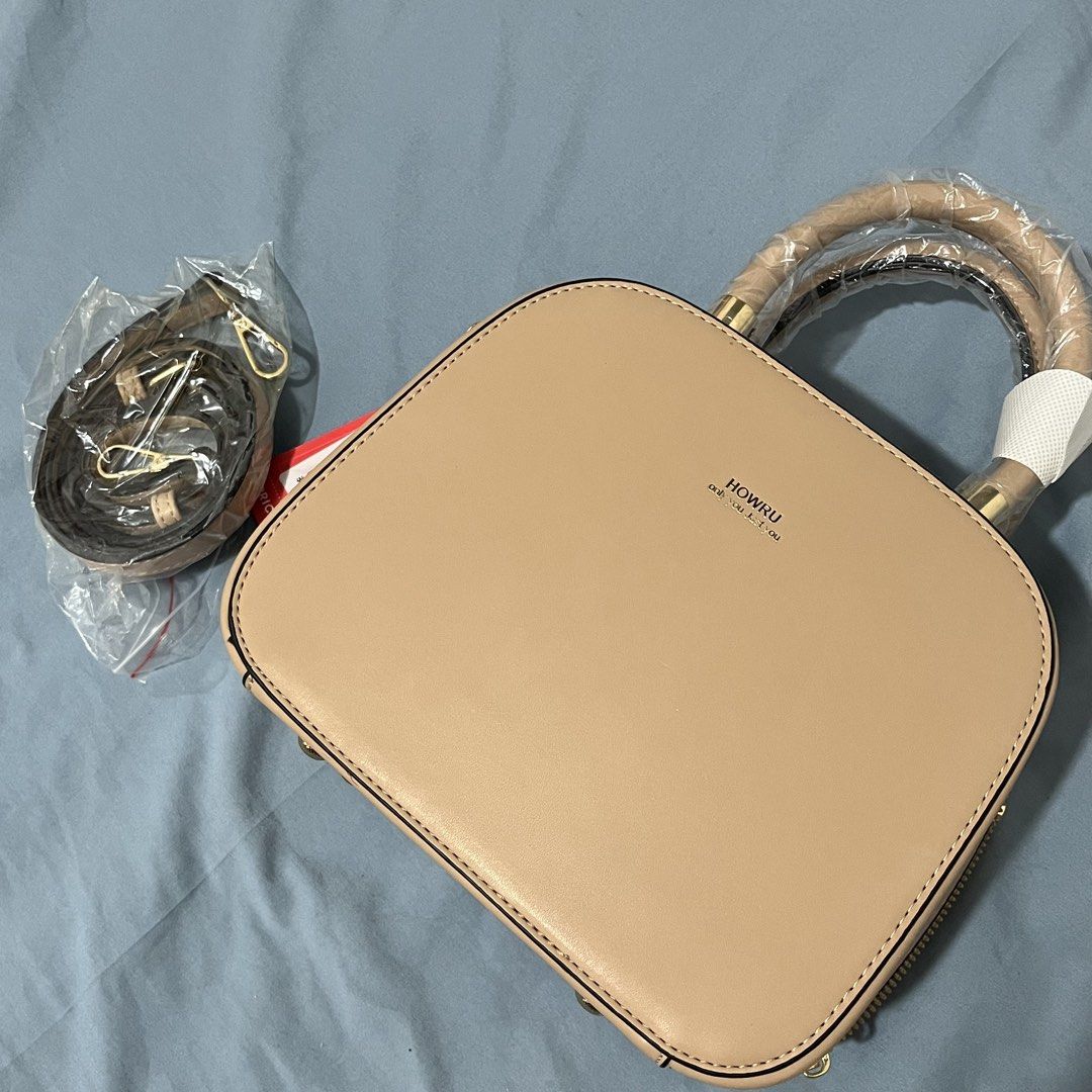 HOWRU Top Handle Bag with Detachable Strap (Category: Shoulder Bags) located in Kalayaan. Submitted by camsiii (Listing ID 1463685980, Image 1). Description: - Never been used -Cute beige top handle bag - Brand: HOWRU - Zipper closure - Detachable shoulder strap included - Handle still has plastic wrap - Brand new with tag attached Bought this for 500php. rfs: Not my style..