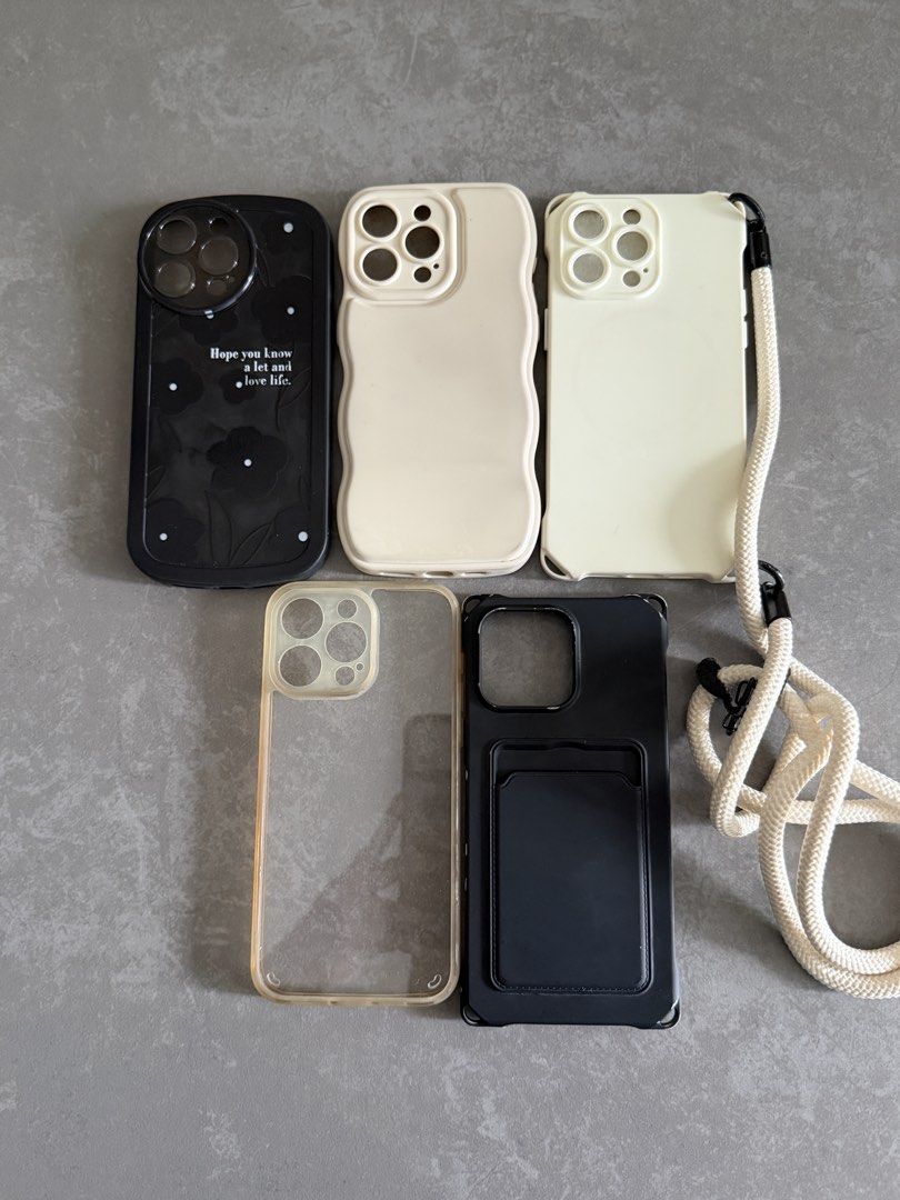 iPhone 15Pro Max Cases Bundle – 5 Cases + Crossbody Case (Category: Cases & Sleeves) located in Taytay. Submitted by thestyletwins (Listing ID 1463603682, Image 2). Description: iPhone Cases Bundle – 5 Cases + Crossbody Case Selling as a bundle of 5 preloved iPhone cases in neutral black, cream and clear designs. Includes: * Black floral case * Cream wavy-edge case * Cream case with detachable crossbody/shoulder strap * Clear case with beige trim