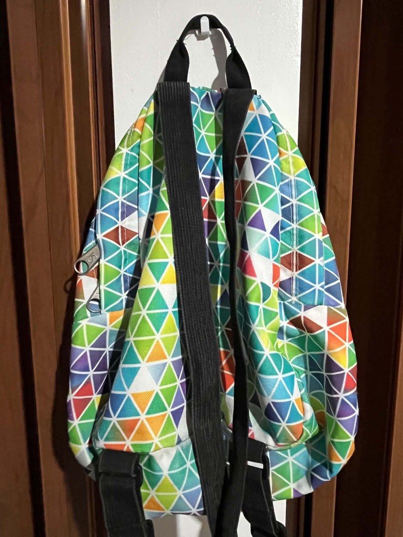 Jansport Backpack - Colorful Geometric Print (Category: Backpacks) located in Quezon City. Submitted by bentot24 (Listing ID 1463695109, Image 3). Description: - Vibrant geometric triangle print Jansport backpack - Main compartment for storage - Front zip pocket for essentials - Adjustable black straps for comfort - Perfect for school or daily use - Zippers work smoothly - Clean inside and out.