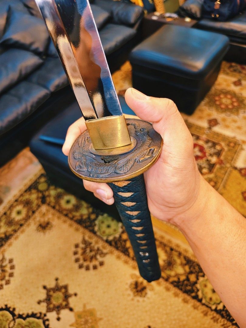Japanese Katana (Category: Vintage Collectibles) located in Dasmarinas. Submitted by jamricana137 (Listing ID 1463677356, Image 3). Description: Featuring a decorative Katana sword (Wakizashi) with an ornate, cast-metal tsuba (handguard) and a dragon motif. Polished metal sword with blunt blade. Decorative metal ornament menuki. Good condition with wooden scabbard.
