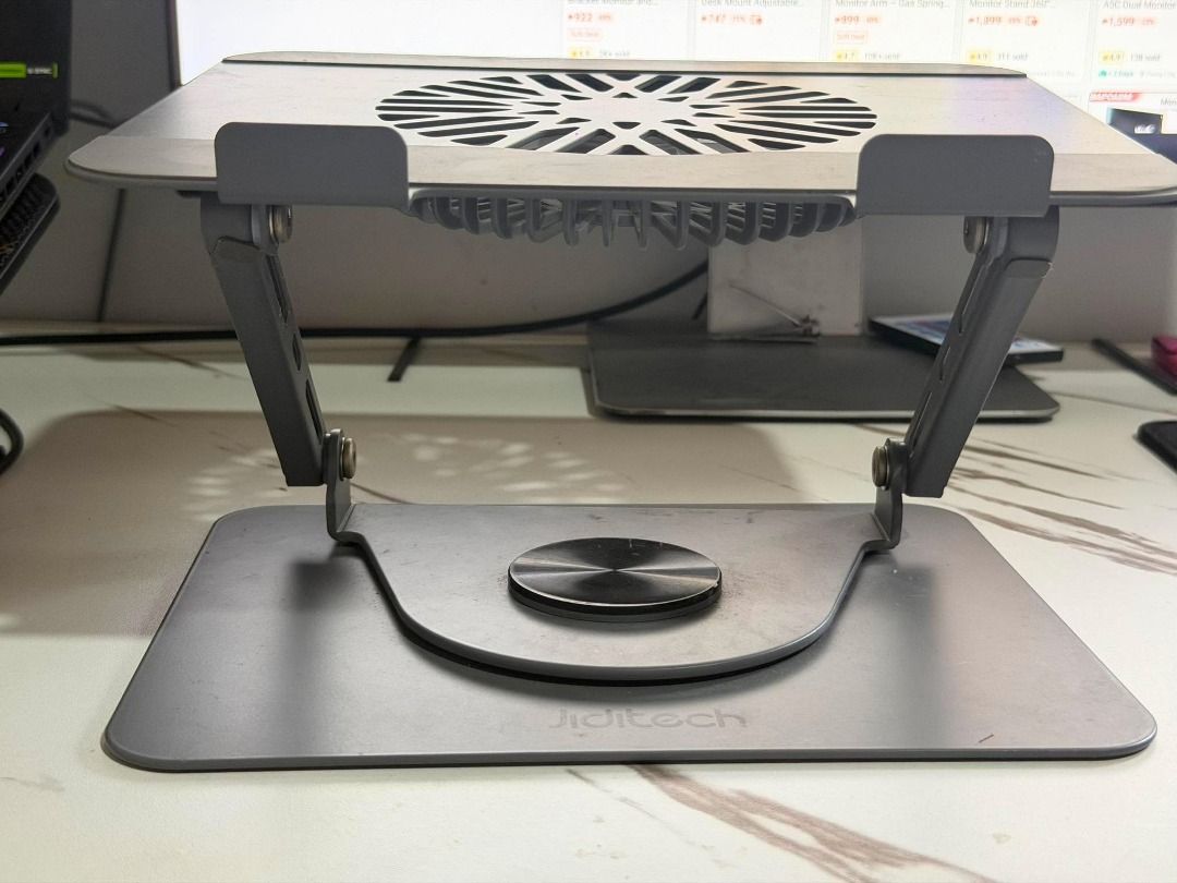 Jiditech 360° Rotating Bracket Laptop Stand with Fan (Category: Other Accessories) located in Silang. Submitted by eburi (Listing ID 1463621159, Image 2). Description: Jiditech 360° Rotating Bracket Laptop Stand with Fan - Magnetic detachable turbo fan - Silicone protection protects your machine Large area silicone pad - Dual devices on the same rack Free your desktop - Infinite rotation, adjust to where you want it - Can be used on laptops/table