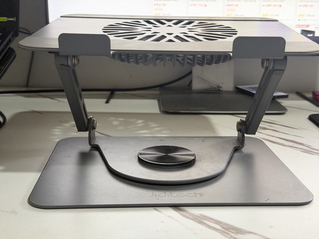 Jiditech Adjustable Laptop Stand with Cooling Fan (Category: Laptops & Notebooks) located in Silang. Submitted by honjinu (Listing ID 1463622254, Image 3). Description: Jiditech 3 IN 1 Laptop Stand With Fan - Used but not abused - Fan works excellently - Magnetic detachable turbo fan - Silicone protection protects your machine Large area silicone pad - Dual devices on the same rack Free your desktop - Infinite rotation, adjust to where you want i