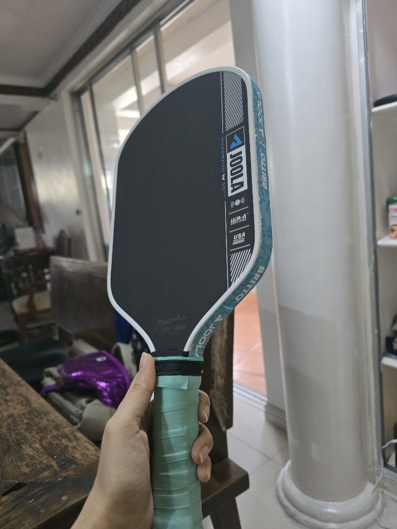 JOOLA Hyperion 16mm Pickleball Paddle (Category: Racket and Ball Sports) located in Paranaque City. Submitted by b.amore (Listing ID 1463711086, Image 3). Description: - JOOLA Hyperion 16mm pickleball paddle - bought in ATC mall alabang, original Price at Php 16k - Features Simone Jardim signature - Comes with a JOOLA paddle cover - Teal grip tape on handle - Ideal for playing pickleball - Power-Control balance - with new edge guard and overgrip 