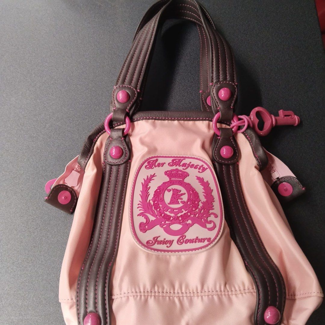 Juicy Couture (Category: Shoulder Bags) located in Quezon City. Submitted by marjoretz (Listing ID 1463570120, Image 1). Description: Vintage Juicy Couture “Her Majesty” Pink & Chocolate Brown Shoulder/ Tote Bag. Y2k-era collectible, nylon body with brown trim ,pink hardware and large Juicy Couture crest. Excellent vintage condition. Purchased in the USA.