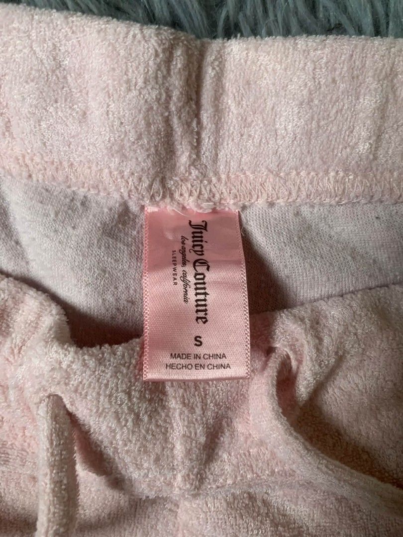 Juicy Couture Velour Track Pants Pink Size S (Category: Jeans) located in Tarlac. Submitted by rhandell_collectives (Listing ID 1463654607, Image 3). Description: - Brand: Juicy Couture - Color: Pink - Material: Velour - Design: Embellished 'Juicy' logo with rhinestones on the back - Features: Elastic waistband with drawstring - Size: S - Origin: Made in China - Perfect for: Lounging or casual wear.