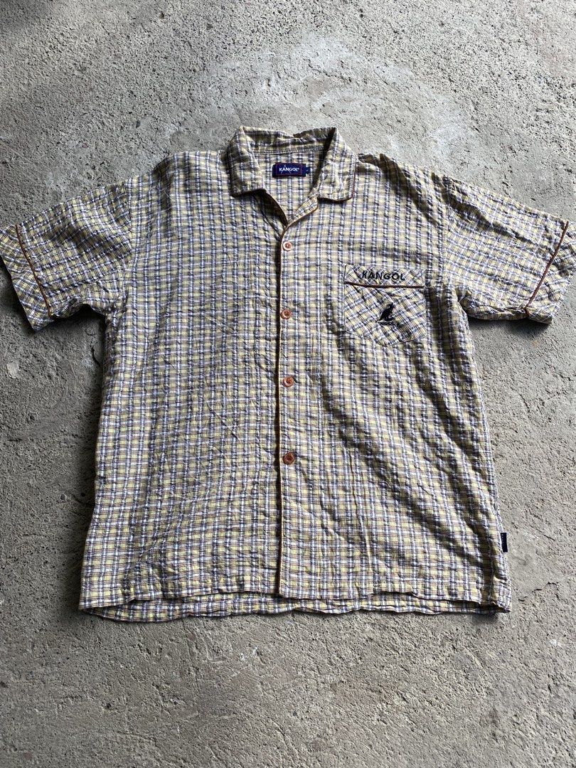 Kangol Plaid Short Sleeve Button Up Shirt (Category: Tshirts & Polo Shirts ) located in Makati City. Submitted by mrbrightside01 (Listing ID 1463627269, Image 1). Description: - Classic Kangol short sleeve shirt - Yellow and blue plaid pattern - Chest pocket with embroidered Kangol logo - Button-up front with brown buttons - Perfect for a casual look - Size: L.
