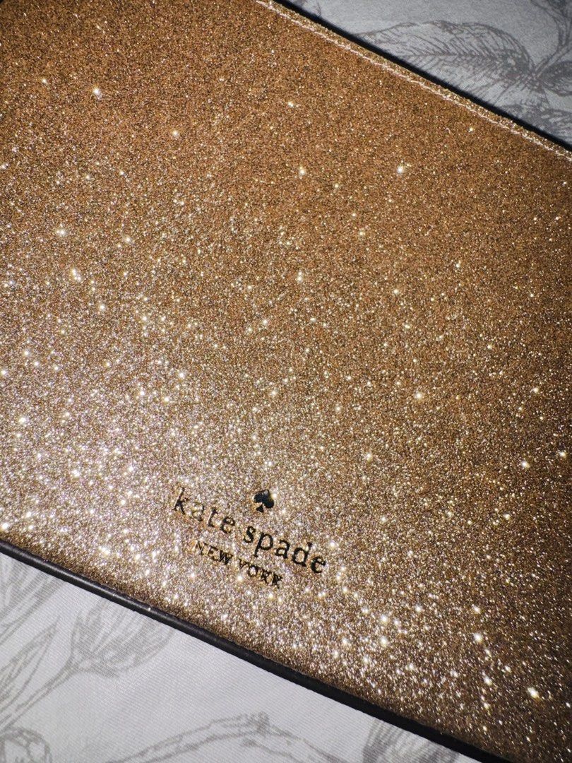 Kate Spade Glimmer Glitter Pochette (Category: Luxury Bags & Wallets) located in Quezon City. Submitted by rachel021 (Listing ID 1463590843, Image 2). Description: Selling my Preloved Authentic Kate Spade New York pochette-style shoulder bag in gold glitter with a gold-tone curb chain strap. Original price: 14k Zip-top closure, "kate spade new york" logo embossed on the front, gold "kate spade" branded hardware on the strap clip. Interior has a s