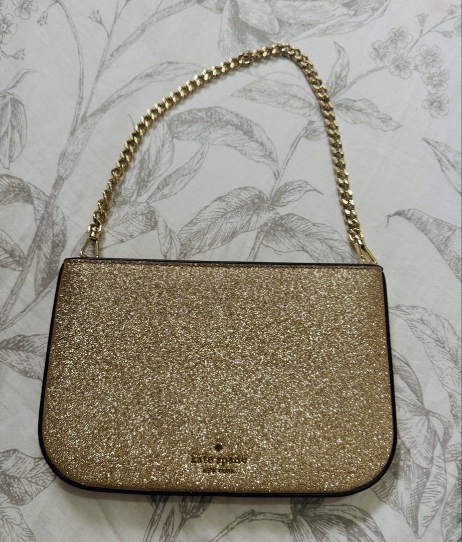 Kate Spade Glimmer Glitter Pochette (Category: Luxury Bags & Wallets) located in Quezon City. Submitted by rachel021 (Listing ID 1463590843, Image 1). Description: Selling my Preloved Authentic Kate Spade New York pochette-style shoulder bag in gold glitter with a gold-tone curb chain strap. Original price: 14k Zip-top closure, "kate spade new york" logo embossed on the front, gold "kate spade" branded hardware on the strap clip. Interior has a s