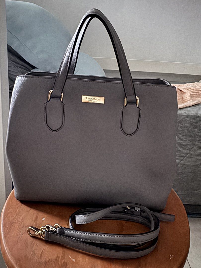 Kate Spade Grey Leather Tote Bag with Shoulder Strap (Category: Tote Bags) located in Las Pinas. Submitted by megalleon8 (Listing ID 1463655104, Image 2). Description: - Genuine leather Kate Spade tote bag in a stylish grey color. - Elegant gold-tone hardware. - Comfortable top handles for easy carrying. - Includes a detachable shoulder strap for versatile wear. - Well-organized interior with a secure zip pocket and multiple compartments. - Both 