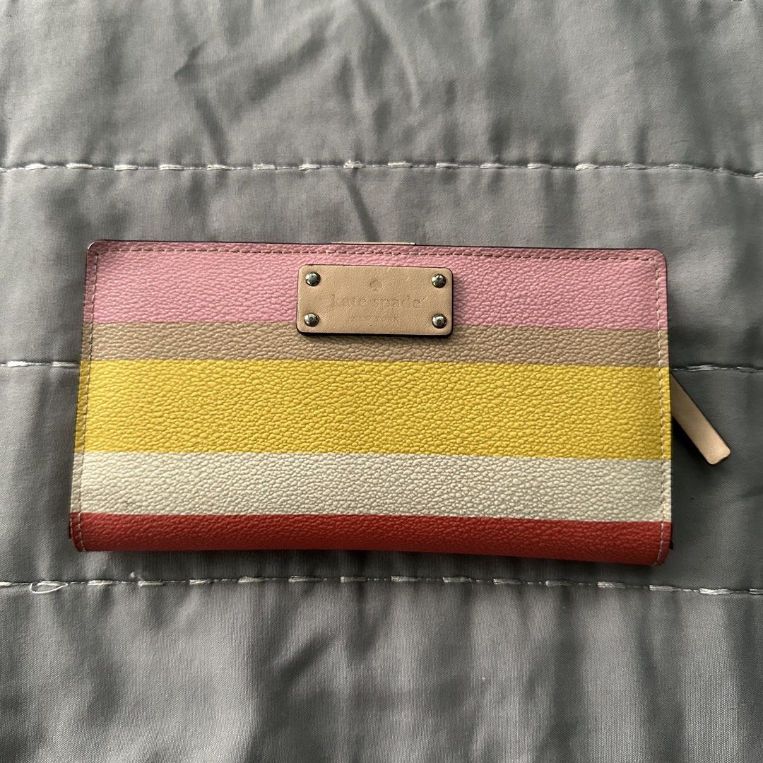 Kate Spade Multicolor Striped Medium Bifold Snap Wallet (Category: Wallets & Card holders) located in Paranaque City. Submitted by ndeclutters (Listing ID 1463640424, Image 1). Description: • Used several times but still functional. • Manage your expectations as it has obvious signs of usage. • You may opt to bring the wallet to a leather or bag repair shop to have it restored. • Issue/s: Has a few stains and some peeling or chipped leather. RFS: