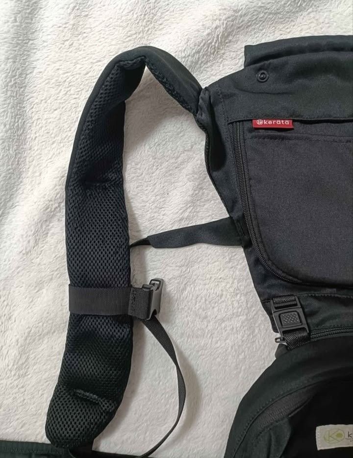 Kerata Baby Carrier (Category: Carriers & Slings) located in Manila. Submitted by luvvicia_21 (Listing ID 1463605223, Image 3). Description: - Black Kerata baby carrier - Padded shoulder straps for comfort - Multiple pockets for convenient storage - Adjustable straps for a secure and personalized fit - Ideal for hands-free baby carrying.