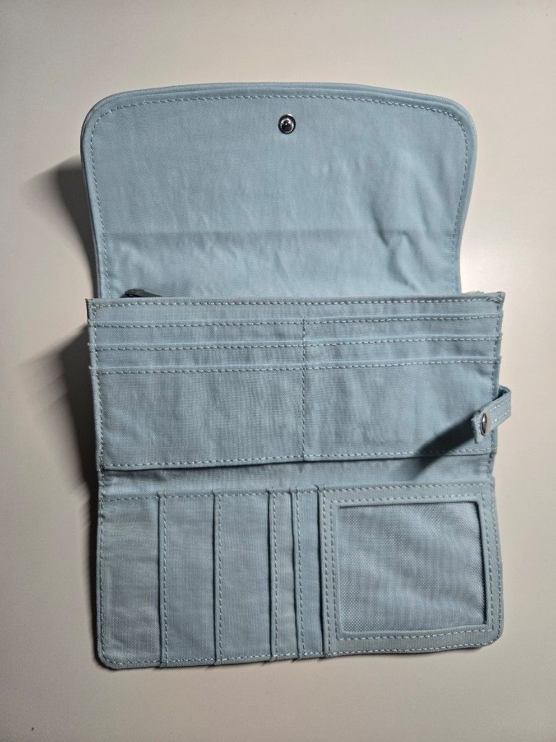 Kipling Blue Wallet Organizer (Category: Wallets & Card holders) located in Cagayan de Oro. Submitted by itsnaja (Listing ID 1463693332, Image 3). Description: - Light blue Kipling wallet - Secure snap closure - Numerous card slots and compartments - Zippered coin pocket - Ideal for on-the-go organization never been used .