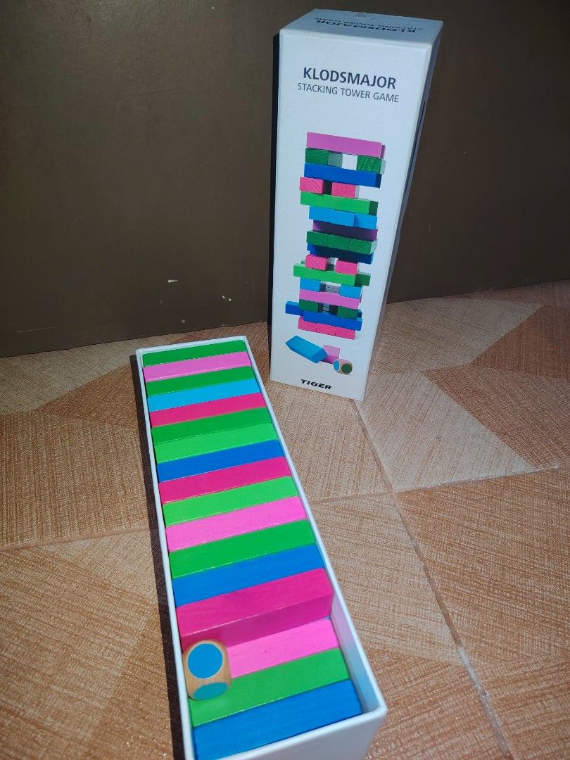 KLODSMAJOR Stacking Tower Game by TIGER (Category: Board Games & Puzzles) located in Santiago. Submitted by aceheart0118672 (Listing ID 1463587731, Image 1). Description: - Fun stacking tower game suitable for all ages. - Comes with colorful wooden blocks and a die. - Ideal for family game nights or parties. - Easy to set up and play. - All blocks are present and accounted for. - Ready for your next game night!.