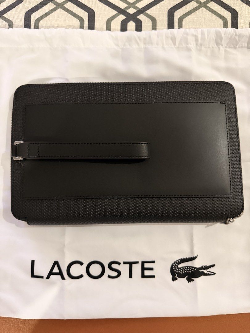 Lacoste Black Leather Zip Around Clutch Bag (Category: Luxury Bags & Wallets) located in Caloocan City. Submitted by rdsupreme (Listing ID 1463658402, Image 2). Description: - Authentic Lacoste black leather clutch - Secure zip-around closure - Convenient wrist strap on the back - Stylish textured panel on the front - Ample space for your essentials - Versatile for everyday use or nights out.