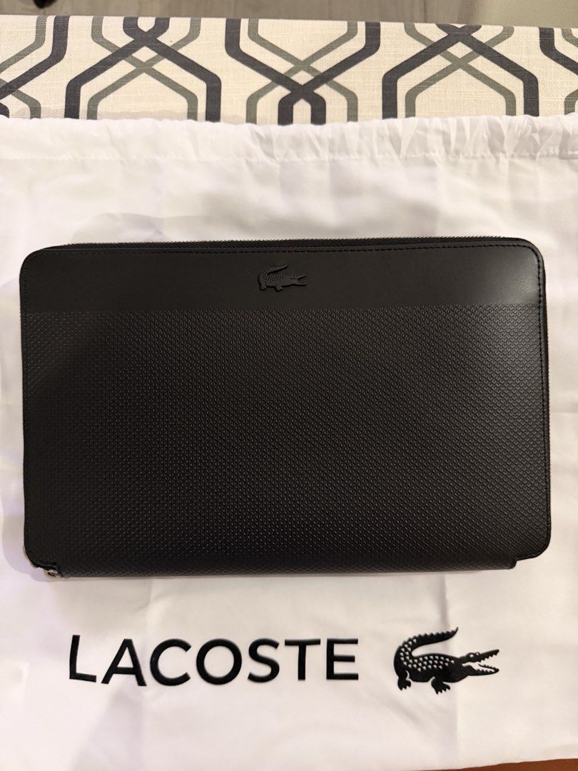 Lacoste Black Leather Zip Around Clutch Bag (Category: Luxury Bags & Wallets) located in Caloocan City. Submitted by rdsupreme (Listing ID 1463658402, Image 1). Description: - Authentic Lacoste black leather clutch - Secure zip-around closure - Convenient wrist strap on the back - Stylish textured panel on the front - Ample space for your essentials - Versatile for everyday use or nights out.