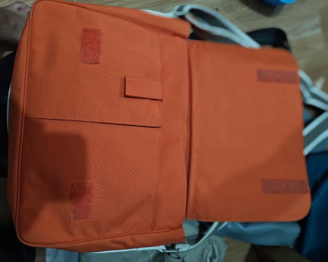 Lacoste Orange Messenger Bag (Category: Sling Bags) located in Baguio. Submitted by solo_ukay (Listing ID 1463694229, Image 3). Description: - Vibrant orange Lacoste messenger bag - Spacious main compartment with interior zip pocket - Front flap with secure velcro closure - Multiple internal pockets for organization - Adjustable strap for comfortable carrying - Ideal for everyday errands or travel adventures.