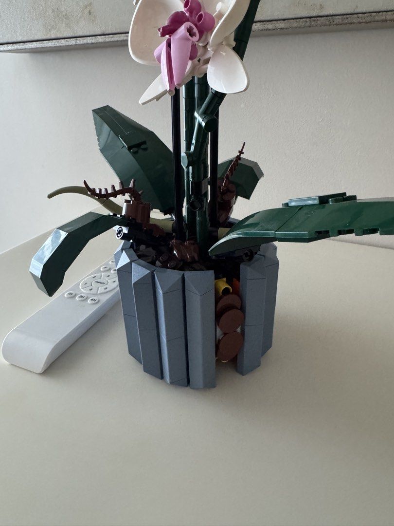 LEGO 10311 Orchid Flower Building Set (Category: Lego & Building Sets) located in Makati City. Submitted by ysabelkgsk (Listing ID 1463601731, Image 2). Description: - One side of the pot lacks 2 blocks but its on the side not the front - Build your own beautiful LEGO Orchid (model 10311). - Features realistic white and pink flowers. - Includes green leaves and a stylish grey pot. - Doesnt come with the box.