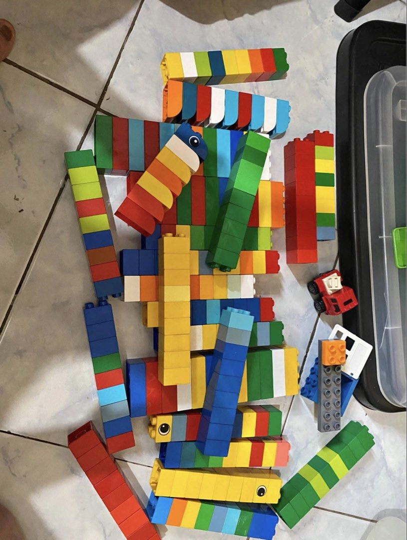 LEGO DUPLO Building Blocks and Figures (Category: Lego & Building Sets) located in Cainta. Submitted by jebo17 (Listing ID 1463577035, Image 1). Description: Mix of original and not original duplo lego with box. Includes bricks, wheels, and character pieces in various sizes and colors. Some are LEGO DUPLO. From a smoke-free home..