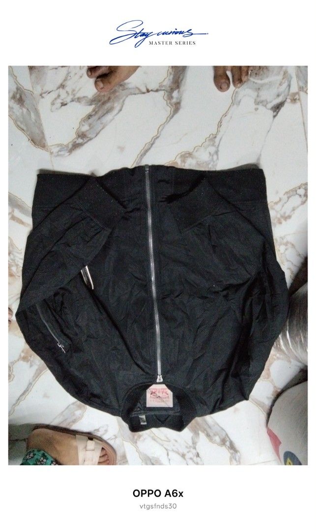 Levi Strauss & Co. Bomber Jacket (Category: Coats, Jackets and Outerwear) located in Manila. Submitted by vtg_finds30 (Listing ID 1463672078, Image 2). Description: - Brand: Levi Strauss & Co. - Style: Black Bomber Jacket - Material: Polyester - Closure: Full zip - Pockets: Zippered side pockets - Features: Ribbed collar, cuffs, and hem - Size: XXL - Ideal for: Everyday wear boxy cropped.