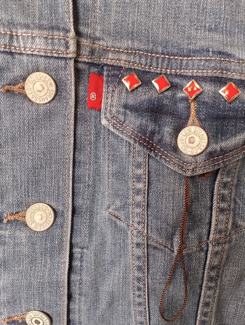 Levi's Denim Jacket with Red Studs (Category: Coats, Jackets and Outerwear) located in Manila. Submitted by jemarlubin04524 (Listing ID 1463573328, Image 3). Description: - Classic Levi's denim jacket - Unique red diamond stud embellishments on front chest pockets and back yoke - Button-up front with buttoned cuffs - Two chest pockets and two side pockets - Nice denim wash - Perfect for layering.