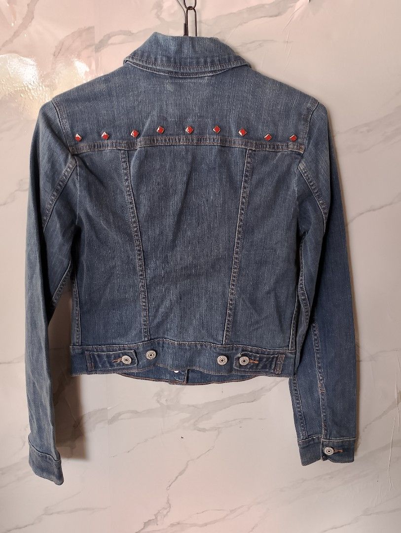 Levi's Denim Jacket with Red Studs (Category: Coats, Jackets and Outerwear) located in Manila. Submitted by jemarlubin04524 (Listing ID 1463573328, Image 2). Description: - Classic Levi's denim jacket - Unique red diamond stud embellishments on front chest pockets and back yoke - Button-up front with buttoned cuffs - Two chest pockets and two side pockets - Nice denim wash - Perfect for layering.