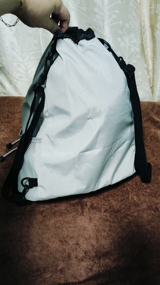 Light Gray Drawstring Bag with Mesh Pockets (Category: Tote Bags) located in Manila. Submitted by serenitycarlylle (Listing ID 1463724576, Image 2). Description: - Stylish light blue drawstring bag - Convenient mesh pocket on the bottom - Internal zippered pocket for secure storage - Easy drawstring closure - Ideal for gym sessions or casual everyday use - Lightweight and easy to carry.