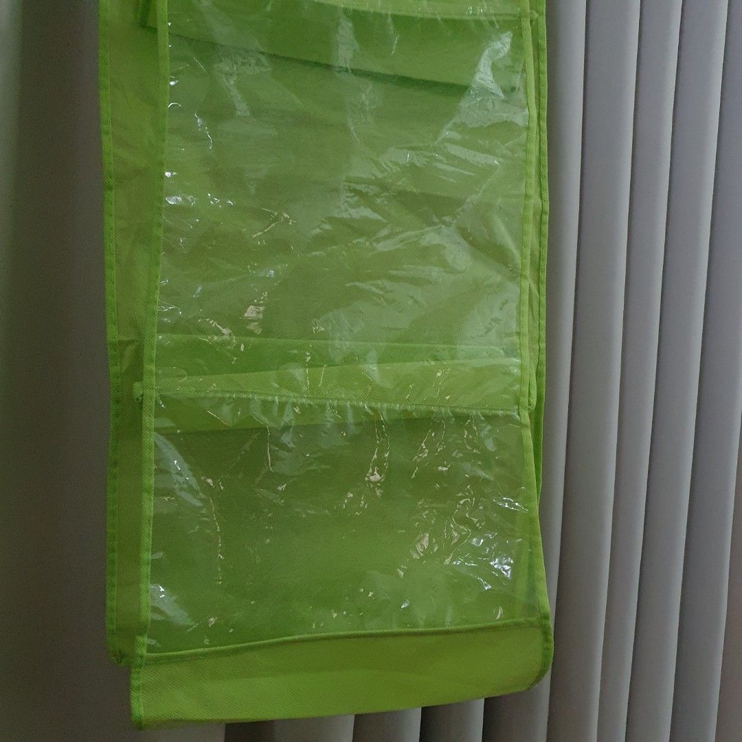 Lime Green Hanging Organizer with Clear Pockets (Category: Accessory Holder, Box & Organizers) located in Paranaque City. Submitted by cobien (Listing ID 1463650771, Image 2). Description: - Keep your space tidy with this versatile hanging organizer. - Features multiple clear pockets for easy visibility of contents. - Ideal for storing accessories, toiletries, craft supplies, and more. - Folds compactly for convenient storage when not in use. - C