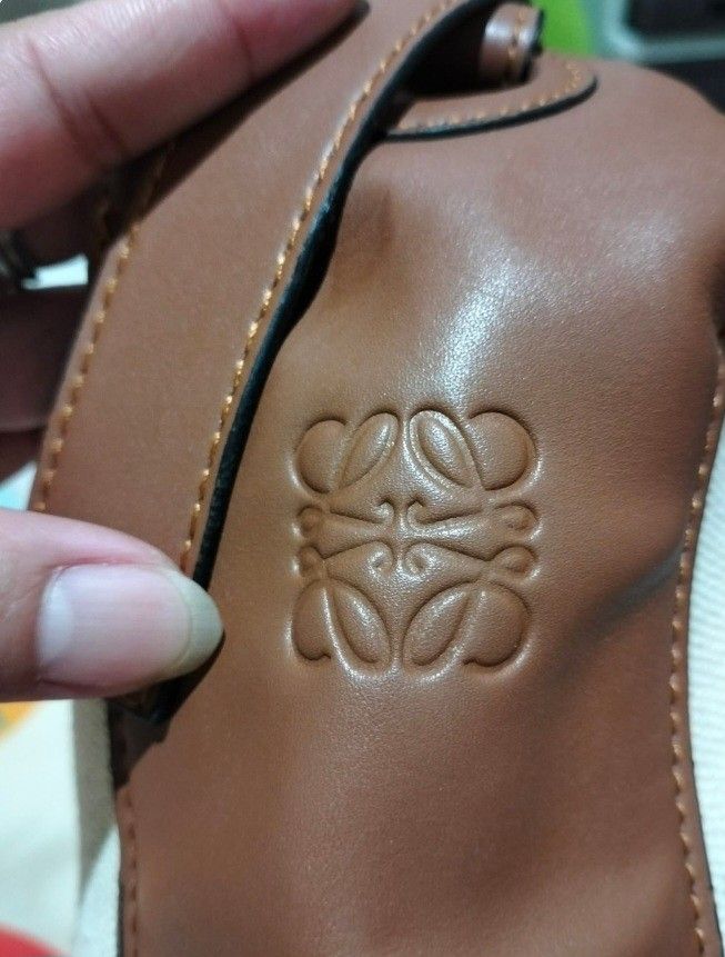 Loewe Anagram Canvas & Leather Bucket Bag (Category: Luxury Bags & Wallets) located in Bay. Submitted by silverhorse-59c851 (Listing ID 1463742103, Image 2). Description: - Loewe Anagram bucket bag - Canvas body with brown leather trim - Embroidered Anagram logo on the front - Interior compartments for organization - Adjustable leather strap - Made in Spain - Ideal everyday bag -issue last picture.