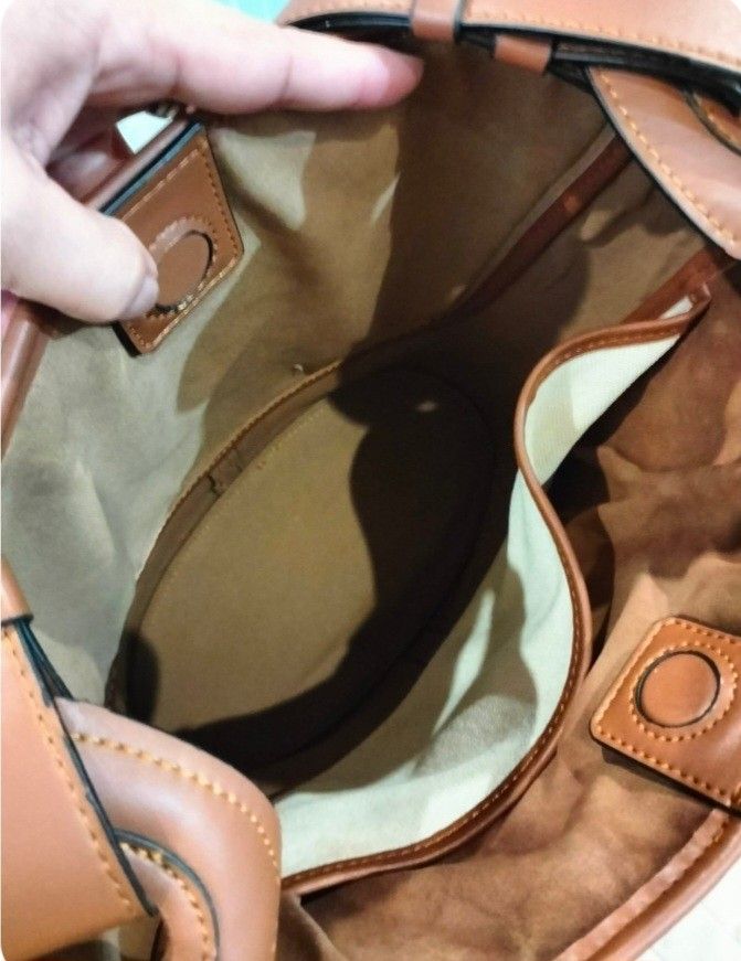 Loewe Anagram Canvas & Leather Bucket Bag (Category: Luxury Bags & Wallets) located in Bay. Submitted by silverhorse-59c851 (Listing ID 1463742103, Image 3). Description: - Loewe Anagram bucket bag - Canvas body with brown leather trim - Embroidered Anagram logo on the front - Interior compartments for organization - Adjustable leather strap - Made in Spain - Ideal everyday bag -issue last picture.