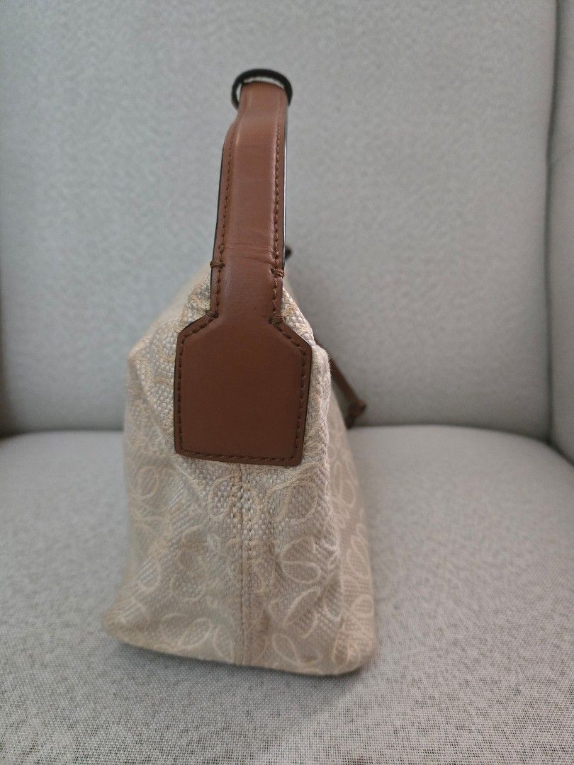 Loewe Anagram Canvas Pouch Bag (Category: Luxury Bags & Wallets) located in Quezon City. Submitted by mrstan777 (Listing ID 1463641436, Image 3). Description: - Authentic Loewe pouch bag - Signature Anagram pattern in beige canvas - Brown leather details - Secure zipclosure - Single, comfortable leather strap - Gold-tone zipper - Ideal for organizing your daily essentials - Was stored for a while, with minor dirt/discoloration, hence selling low.