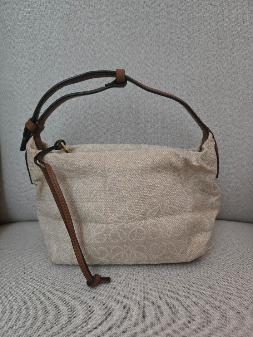 Loewe Anagram Canvas Pouch Bag (Category: Luxury Bags & Wallets) located in Quezon City. Submitted by mrstan777 (Listing ID 1463641436, Image 2). Description: - Authentic Loewe pouch bag - Signature Anagram pattern in beige canvas - Brown leather details - Secure zipclosure - Single, comfortable leather strap - Gold-tone zipper - Ideal for organizing your daily essentials - Was stored for a while, with minor dirt/discoloration, hence selling low.