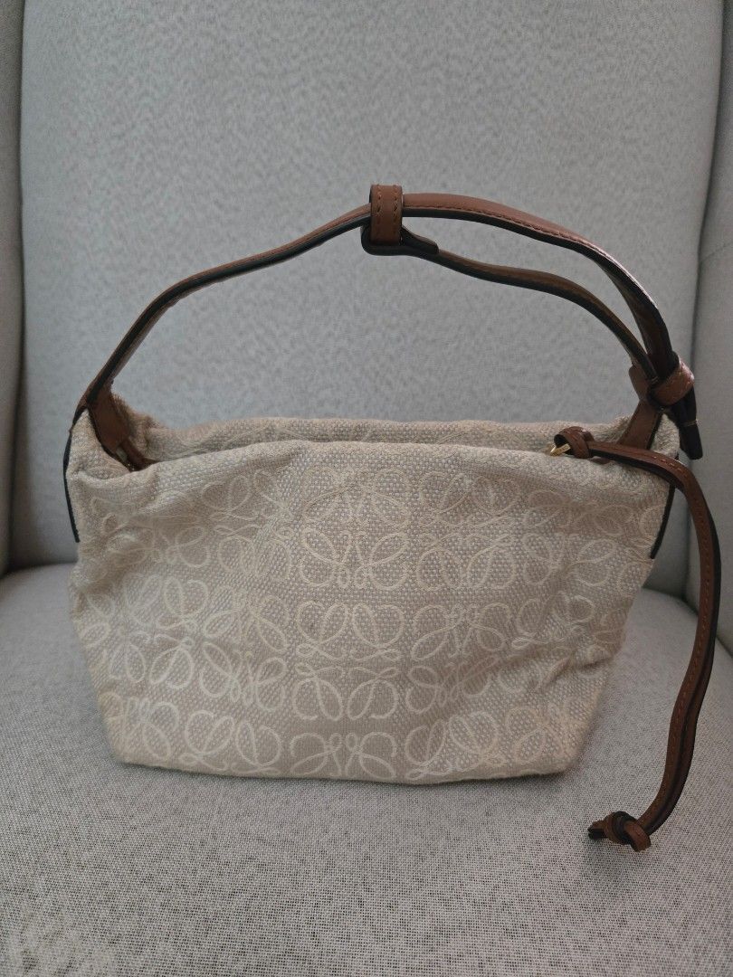 Loewe Anagram Canvas Pouch Bag (Category: Luxury Bags & Wallets) located in Quezon City. Submitted by mrstan777 (Listing ID 1463641436, Image 1). Description: - Authentic Loewe pouch bag - Signature Anagram pattern in beige canvas - Brown leather details - Secure zipclosure - Single, comfortable leather strap - Gold-tone zipper - Ideal for organizing your daily essentials - Was stored for a while, with minor dirt/discoloration, hence selling low.