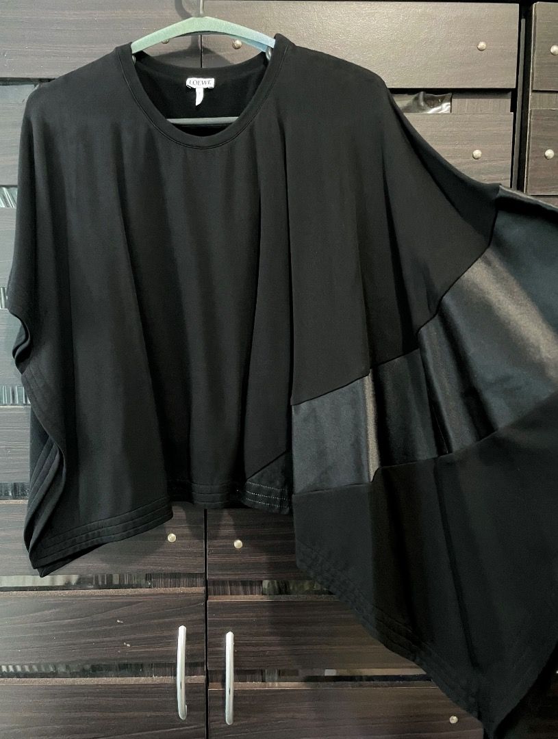 Loewe black asymmetric batwing blouse top (Category: Blouses) located in Quezon City. Submitted by angelbuena38328 (Listing ID 1463596352, Image 2). Description: Black Loewe batwing blouse with one side longer than the right side, has a heavy thick satin panel design. Size small to medium . Dry cleaned almost new Check out my other items . Constantly decluttering .