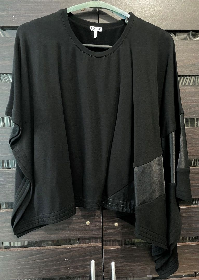 Loewe black asymmetric batwing blouse top (Category: Blouses) located in Quezon City. Submitted by angelbuena38328 (Listing ID 1463596352, Image 1). Description: Black Loewe batwing blouse with one side longer than the right side, has a heavy thick satin panel design. Size small to medium . Dry cleaned almost new Check out my other items . Constantly decluttering .
