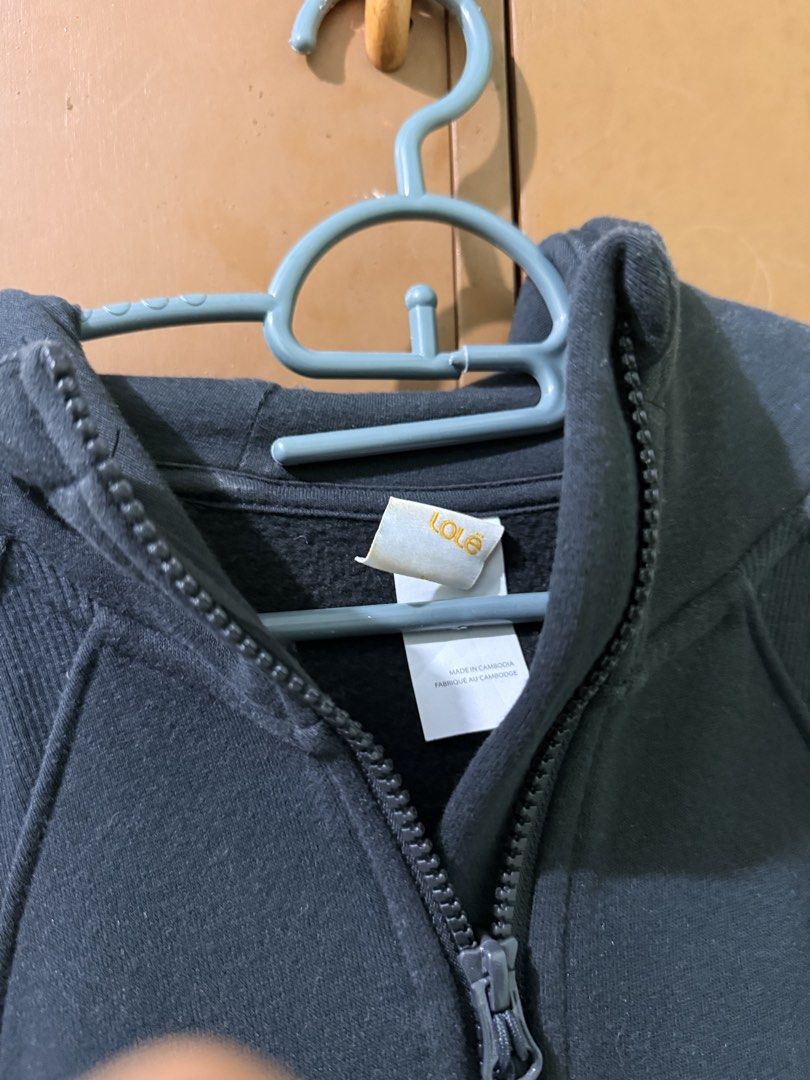 Lole Black Zip-Up Hoodie (Category: Coats, Jackets and Outerwear) located in Lucena. Submitted by lcndeclutter (Listing ID 1463648720, Image 2). Description: - Black Lole hoodie - Quarter zip closure - Front pouch pocket - Hooded design - Lole logo detail on sleeve - Made in Cambodia - Ideal for casual wear or layering.