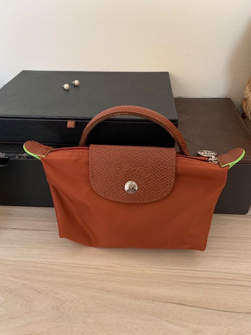 Longchamp Le Pliage Cosmetic Pouch Orange (Category: Luxury Bags & Wallets) located in Quezon City. Submitted by mycloset_888 (Listing ID 1463650560, Image 1). Description: - Authentic Orange Longchamp cosmetic pouch - Genuine leather trim and handle - Secure zipper closure - Compact and ideal for organizing makeup and small essentials - Stylish neon green accents on zipper tabs AUTHENTIC!.