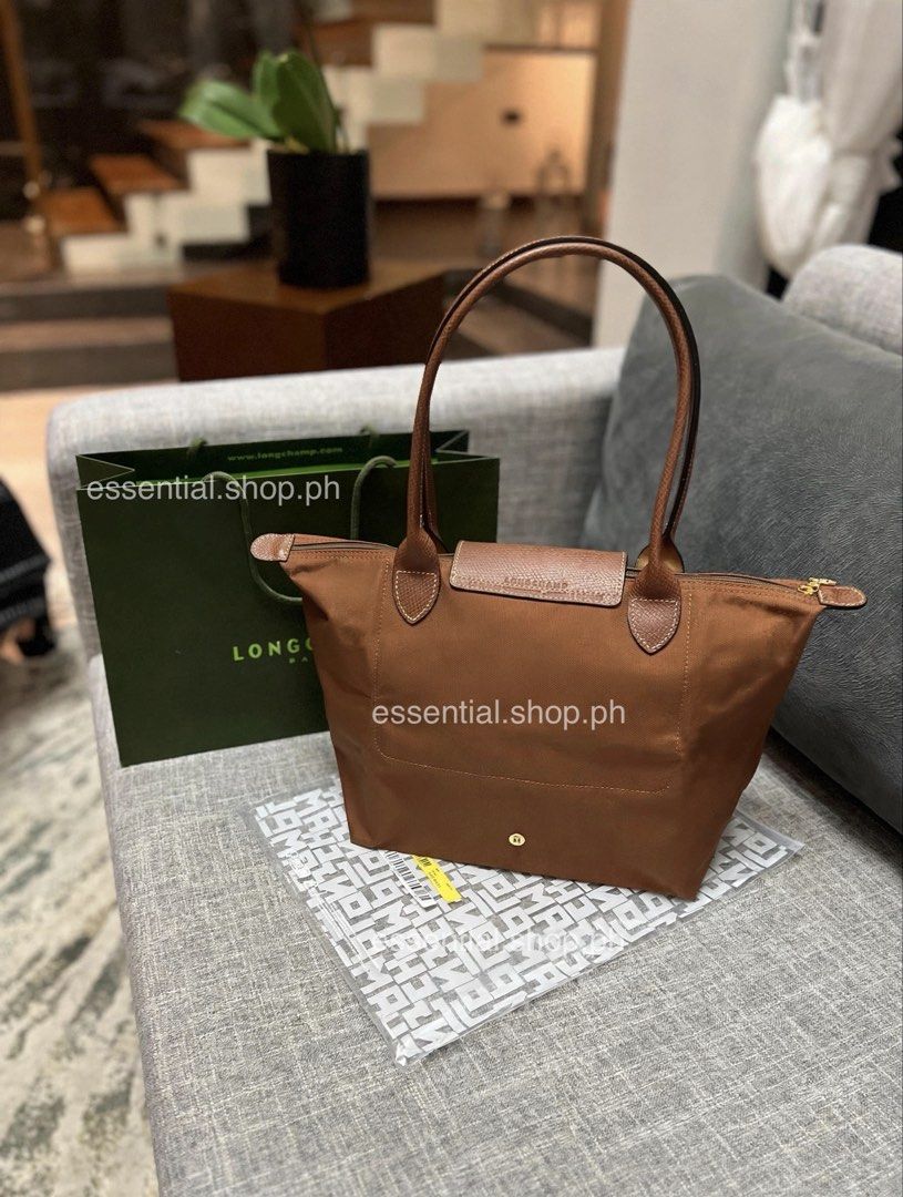 Longchamp Le Pliage Original Medium Long Handle in Cognac (Category: Luxury Bags & Wallets) located in Manila. Submitted by essential.shop.ph (Listing ID 1463657799, Image 2). Description: FOR PRE-ORDER. 7-10 days ETA ☺️ Authentic Longchamp Le Pliage Original Medium Long Handle Cognac (Actual color difficult to capture. Changes due to lighting.) Includes care card, LGP zip lock pouch and paper bag. Dimensions 28 cm (L - measured at the base of th