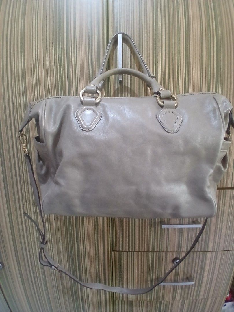 Louis Quatorze Leather Handbag Shoulder Bag (Category: Luxury Bags & Wallets) located in Taguig. Submitted by demsclosetph (Listing ID 1463618694, Image 2). Description: - Authentic Louis Quatorze taupe leather handbag - Versatile with top handles and a detachable shoulder strap - Elegant gold hardware details - Interior features a chic patterned lining and a secure zip pocket - Please note: Some signs of wear on the leather and strap are present