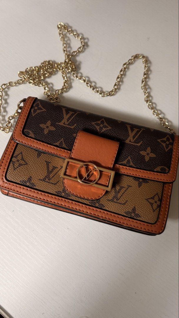 Louis Vuitton Monogram Canvas Dauphine Chain Wallet (Category: Luxury Bags & Wallets) located in Batangas. Submitted by cjayf (Listing ID 1463599831, Image 1). Description: - Cute crossbody bag with classic monogram print - Secure gold buckle closure - Detachable gold chain strap for versatile styling - Ideal for carrying your daily essentials - Chic and stylish accessory .