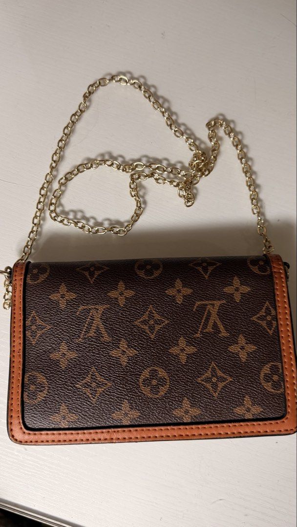 Louis Vuitton Monogram Canvas Dauphine Chain Wallet (Category: Luxury Bags & Wallets) located in Batangas. Submitted by cjayf (Listing ID 1463599831, Image 2). Description: - Cute crossbody bag with classic monogram print - Secure gold buckle closure - Detachable gold chain strap for versatile styling - Ideal for carrying your daily essentials - Chic and stylish accessory .