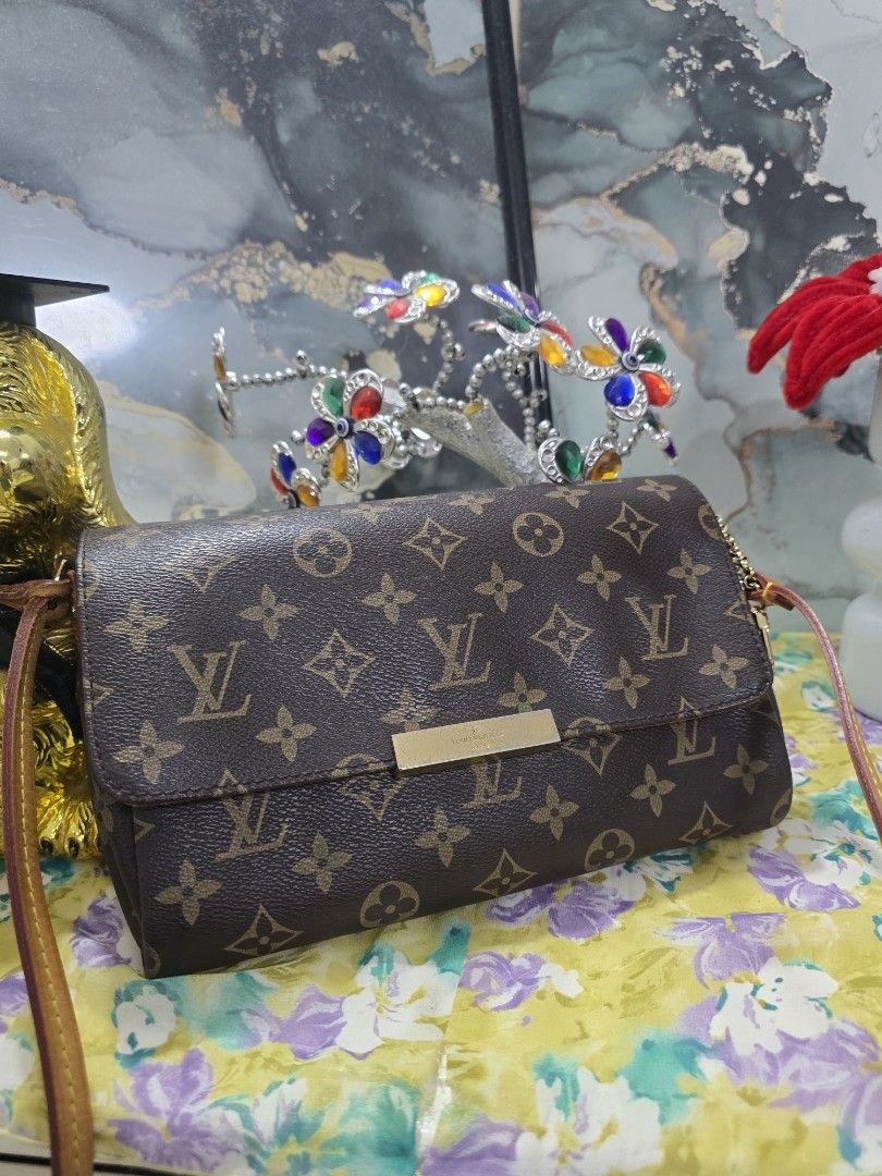 Louis Vuitton Monogram Clutch Bag (Category: Luxury Bags & Wallets) located in Binan City. Submitted by geraldinef58404 (Listing ID 1463652379, Image 1). Description: - Authentic Louis Vuitton monogram clutch - Classic brown and tan design - Gold hardware detail on front flap - Deep burgundy interior with a pocket - Adjustable strap - Ideal for evenings out or as a statement piece.