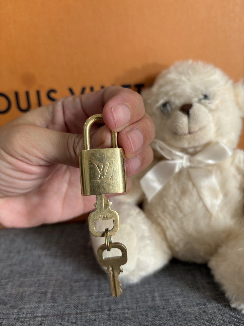 Louis Vuitton Padlock with 2 Keys (Category: Luxury Bags & Wallets) located in Alicia. Submitted by berly06 (Listing ID 1463577194, Image 3). Description: - Authentic Louis Vuitton padlock - Gold tone hardware - Engraved with LV monogram - Includes two matching keys - Ideal for securing small bags or as a collectible.