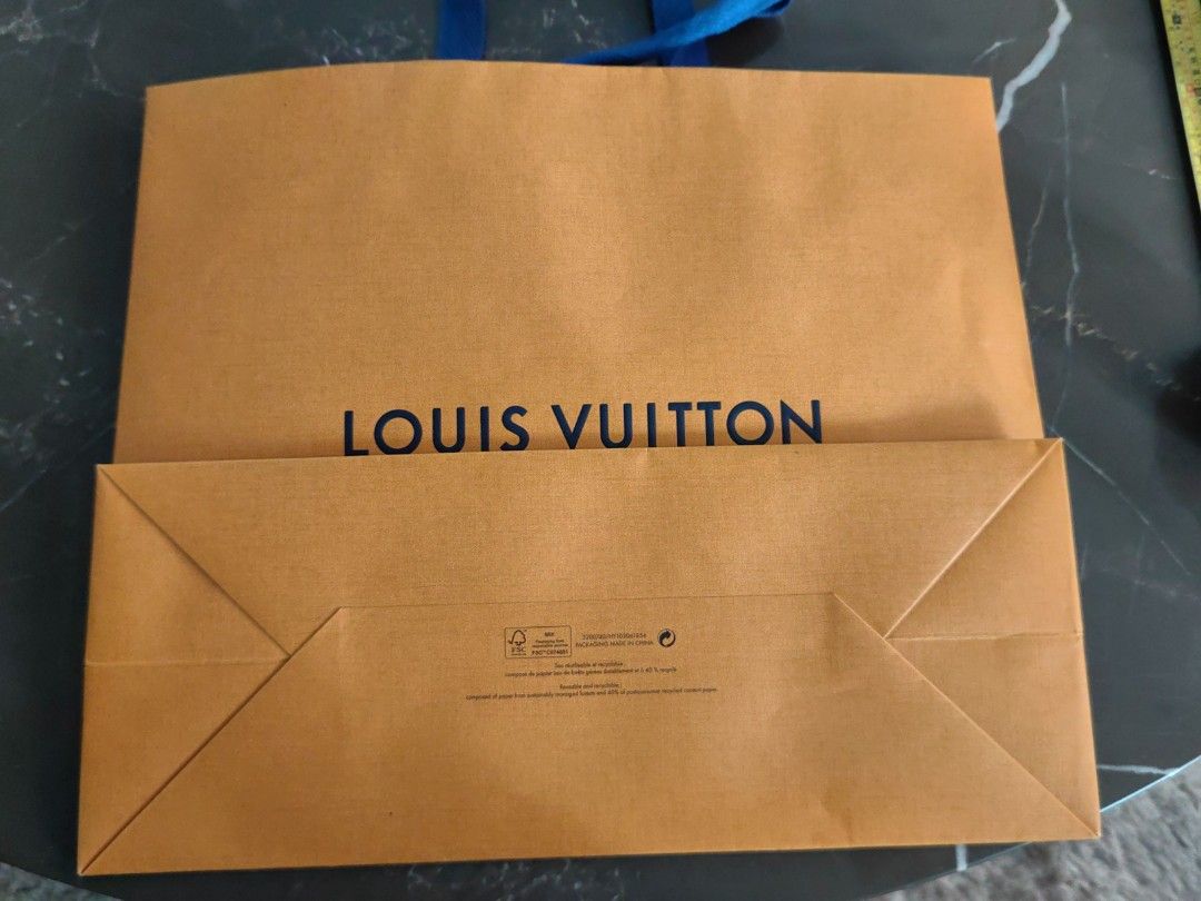 Louis Vuitton Shopping Bag (Category: Luxury Bags & Wallets) located in Makati City. Submitted by kruelscloset (Listing ID 1463602861, Image 2). Description: - Authentic Louis Vuitton paper shopping bag - Color: Orange with blue handles - Approximate dimensions: 13 inches height, length 16in - Features "Maison fondée en 1854 Paris" - Ideal for storing or gifting Louis Vuitton purchases - Condition: Clean and sturdy.