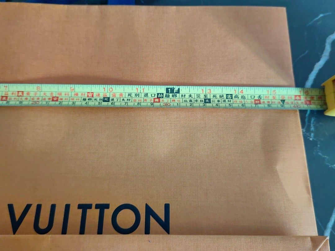 Louis Vuitton Shopping Bag (Category: Luxury Bags & Wallets) located in Makati City. Submitted by kruelscloset (Listing ID 1463602861, Image 3). Description: - Authentic Louis Vuitton paper shopping bag - Color: Orange with blue handles - Approximate dimensions: 13 inches height, length 16in - Features "Maison fondée en 1854 Paris" - Ideal for storing or gifting Louis Vuitton purchases - Condition: Clean and sturdy.