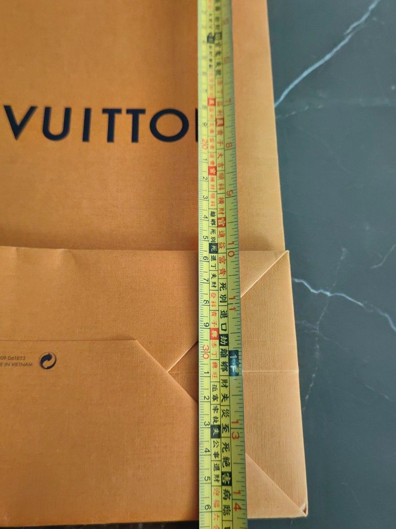 Louis Vuitton Shopping Bag (Category: Luxury Accessories) located in Makati City. Submitted by kruelscloset (Listing ID 1463603304, Image 3). Description: - Authentic Louis Vuitton paper shopping bag - Color: Orange with blue ribbon handles - "Maison Fondee En 1854 Paris" detail - Made in Vietnam - Approximate dimensions: 25cm (width) x 36cm (height) - Ideal for gifting or storing small items.