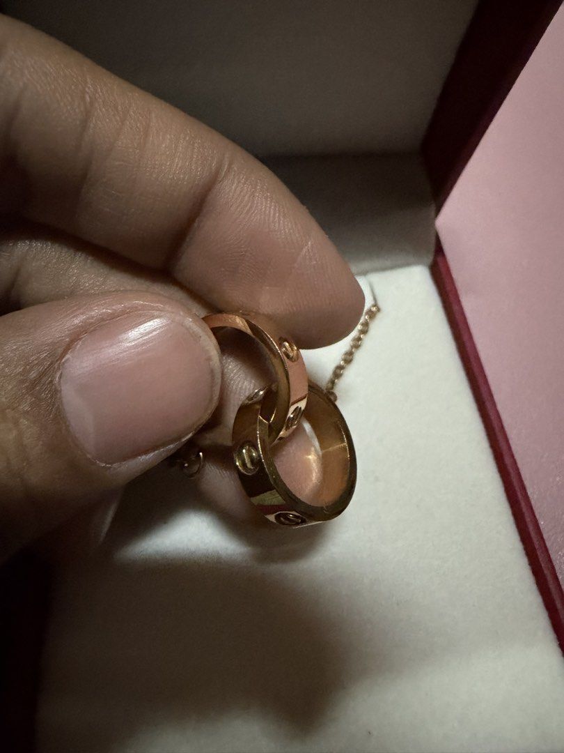 Love C@rtier Rose Gold Interlocking Rings Necklace (Category: Necklaces) located in Pasig City. Submitted by aprilluxcloset0812 (Listing ID 1463737735, Image 2). Description: - Elegant rose gold necklace - Features two interlocking rings - One ring engraved with 'love' - Second ring has delicate circular engravings - Ideal for daily wear or special events Fashion Accessories ONLY, NO BOX (Box is for photo ops purpose only) Small ziplock included 