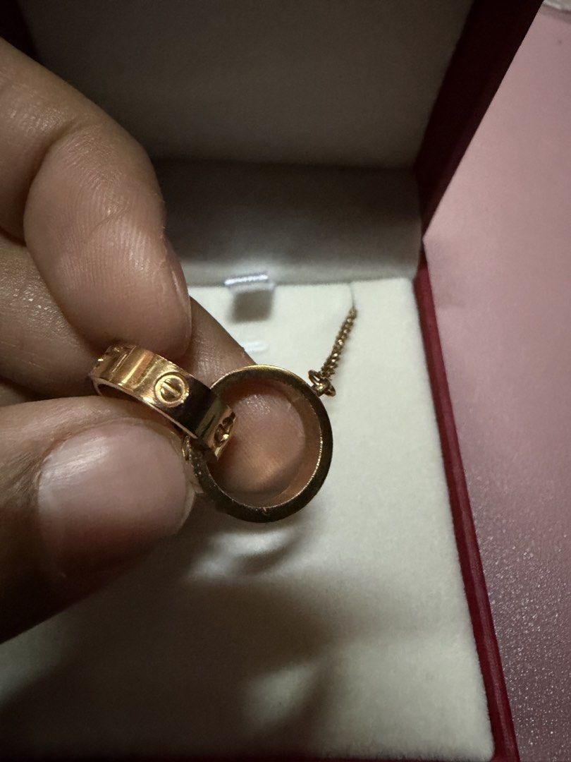 Love C@rtier Rose Gold Interlocking Rings Necklace (Category: Necklaces) located in Pasig City. Submitted by aprilluxcloset0812 (Listing ID 1463737735, Image 3). Description: - Elegant rose gold necklace - Features two interlocking rings - One ring engraved with 'love' - Second ring has delicate circular engravings - Ideal for daily wear or special events Fashion Accessories ONLY, NO BOX (Box is for photo ops purpose only) Small ziplock included 