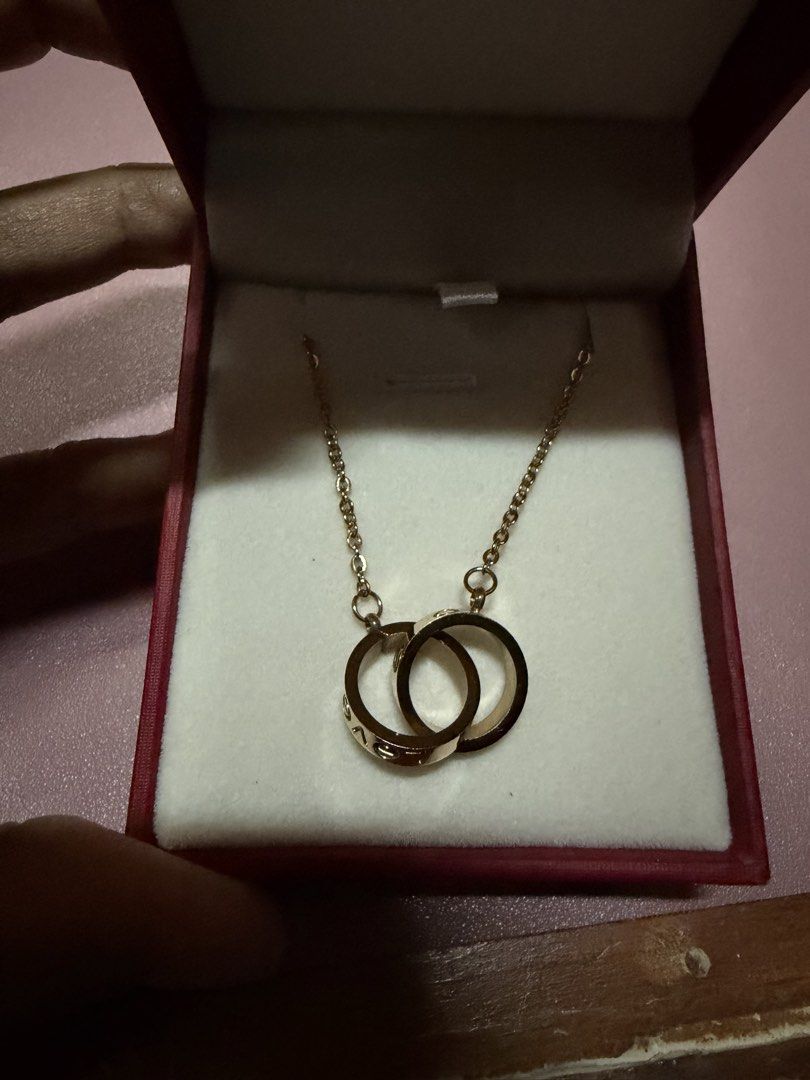Love C@rtier Rose Gold Interlocking Rings Necklace (Category: Necklaces) located in Pasig City. Submitted by aprilluxcloset0812 (Listing ID 1463737735, Image 1). Description: - Elegant rose gold necklace - Features two interlocking rings - One ring engraved with 'love' - Second ring has delicate circular engravings - Ideal for daily wear or special events Fashion Accessories ONLY, NO BOX (Box is for photo ops purpose only) Small ziplock included 
