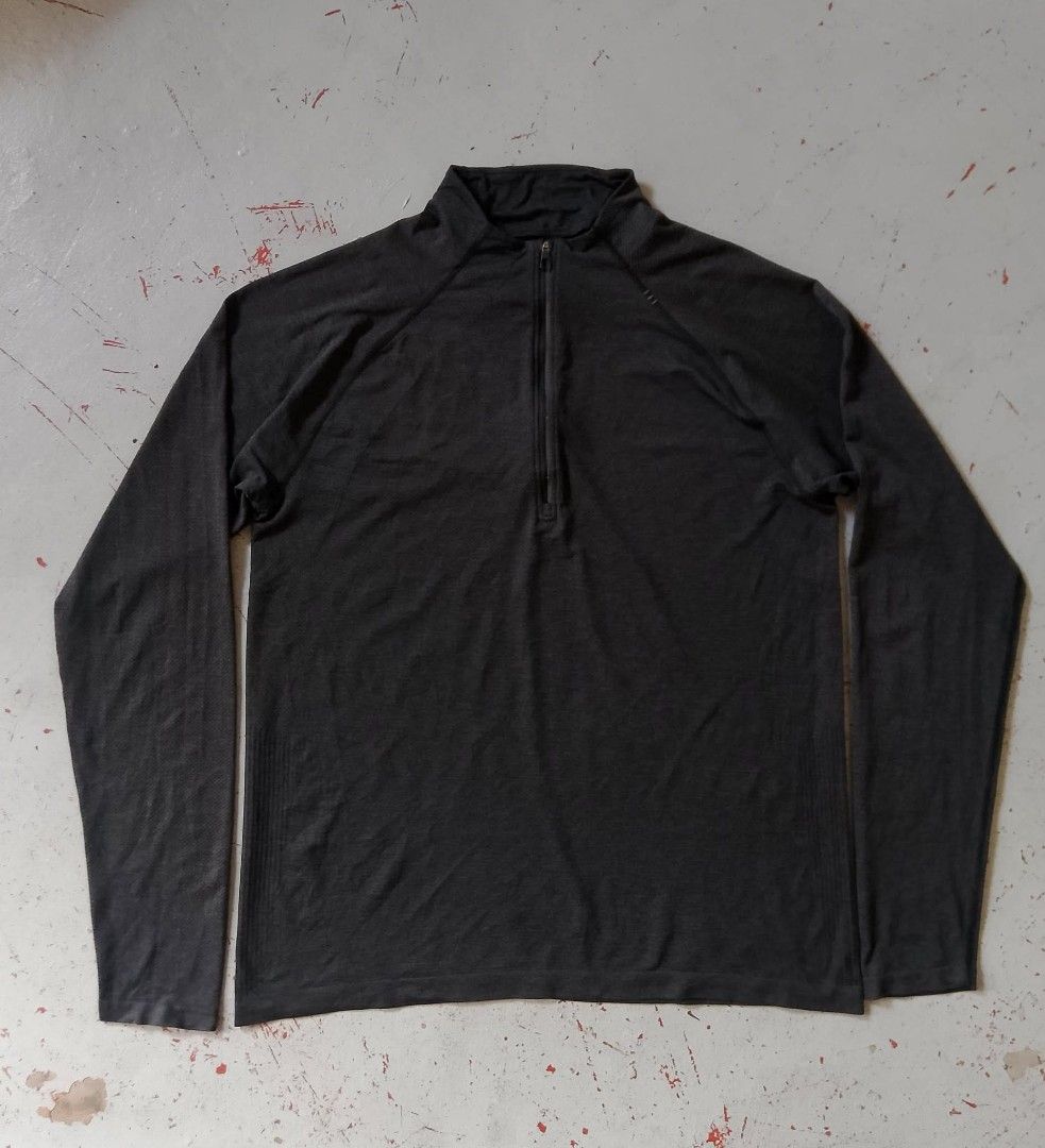 Lululemon Long Sleeve Half Zip Top (Category: Announcements) located in Quezon City. Submitted by cruz_robert (Listing ID 1463621460, Image 1). Description: Dark grey Lululemon long sleeve top. Has a half zip neckline and a stand-up collar. The fabric has a subtle textured pattern. "LIVE IN PRACTICE" is printed along the hem. Great for workouts or casual wear. Large 23-29.